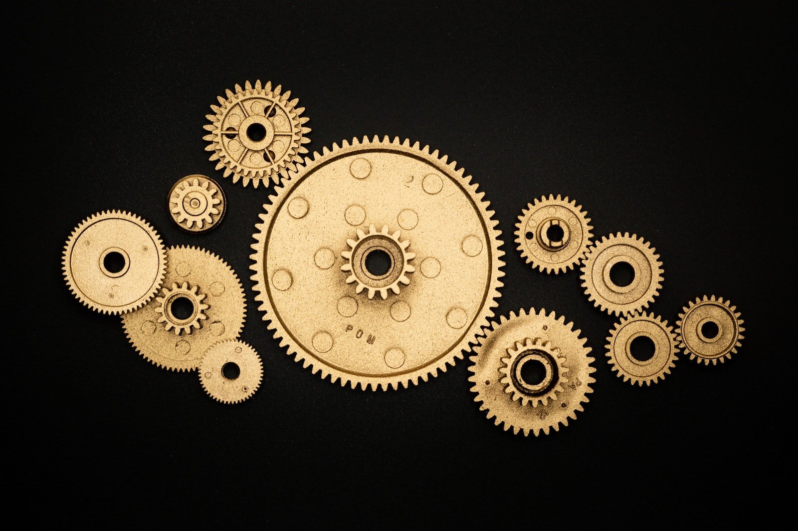 Photo of Golden Cogwheel on Black Background