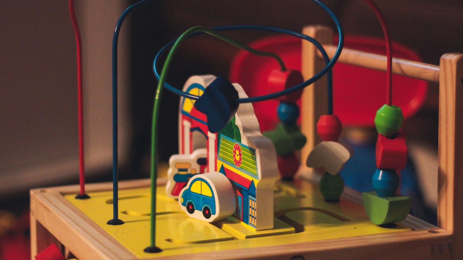 a wooden toy with a train and cars on it