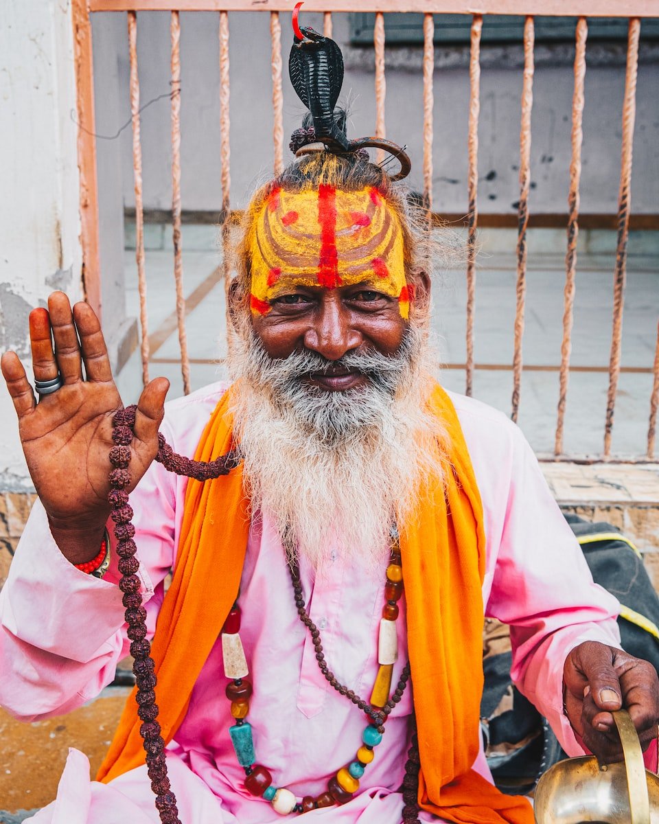 man in white long sleeve shirt with yellow and red face paint