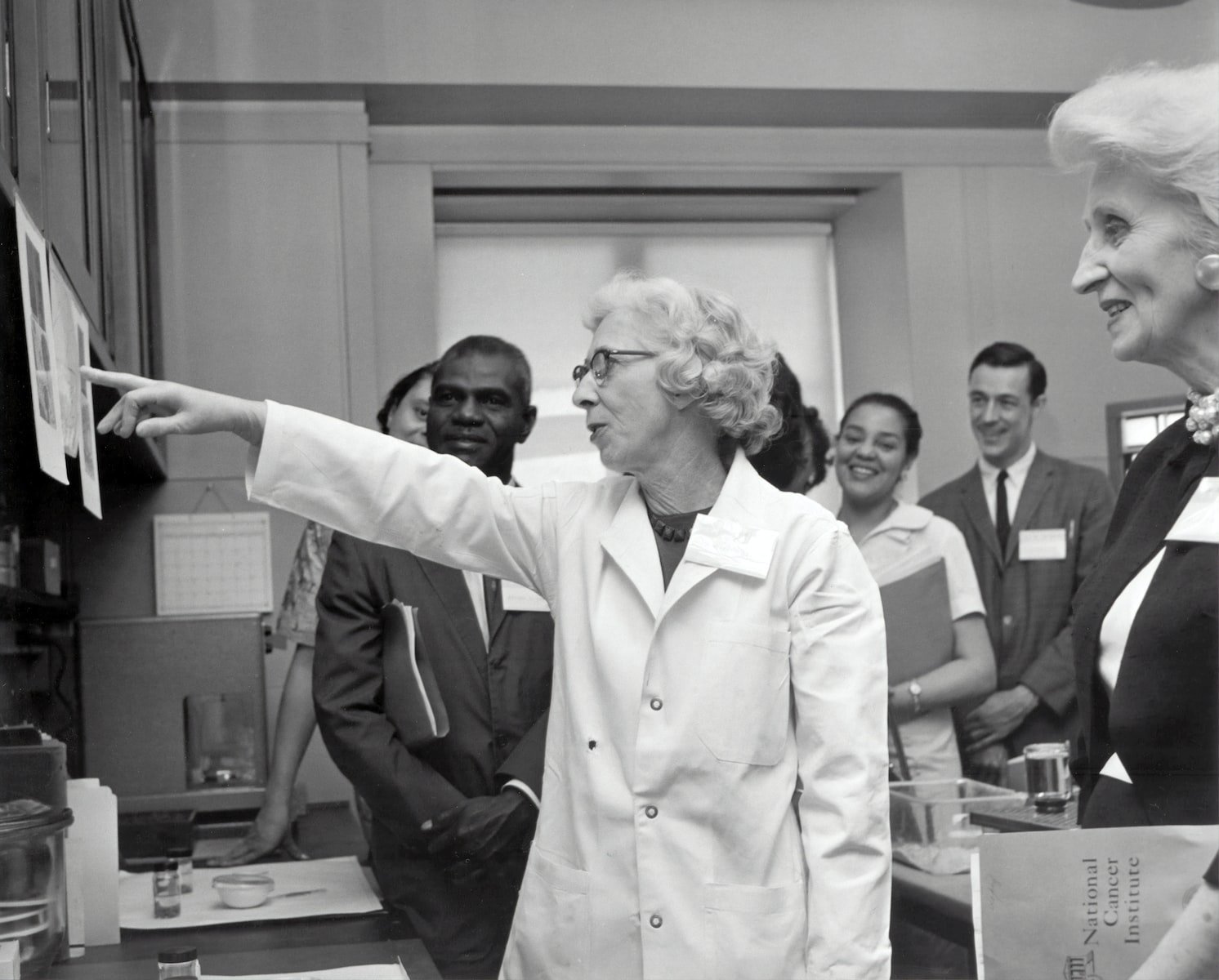 grayscale photo of doctors inside laboratory