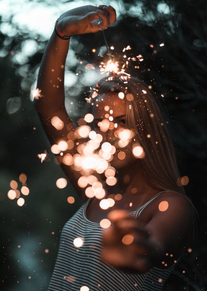 woman holding sparklers bokeh photography