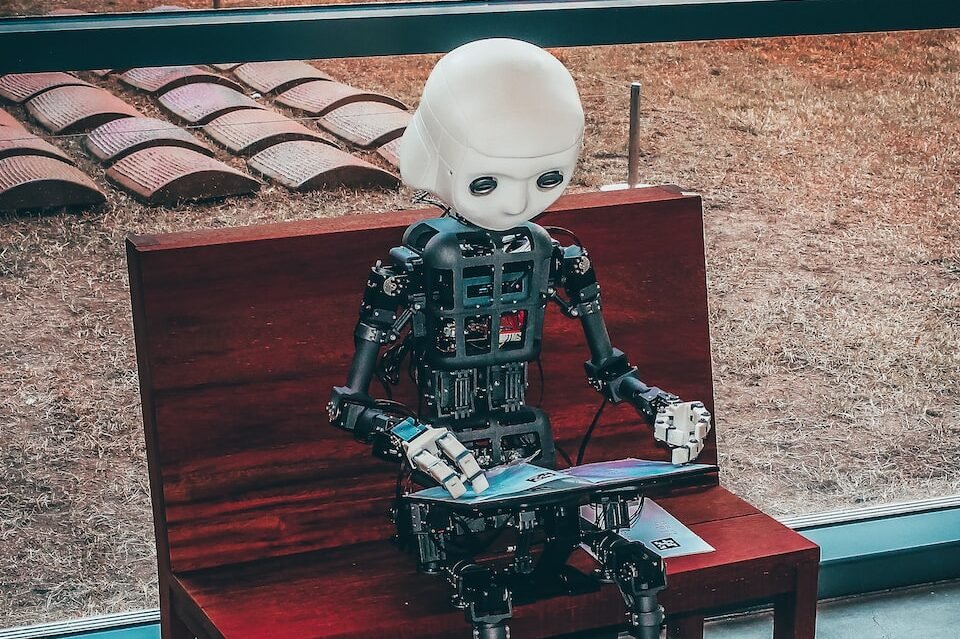 black and white robot toy on red wooden table